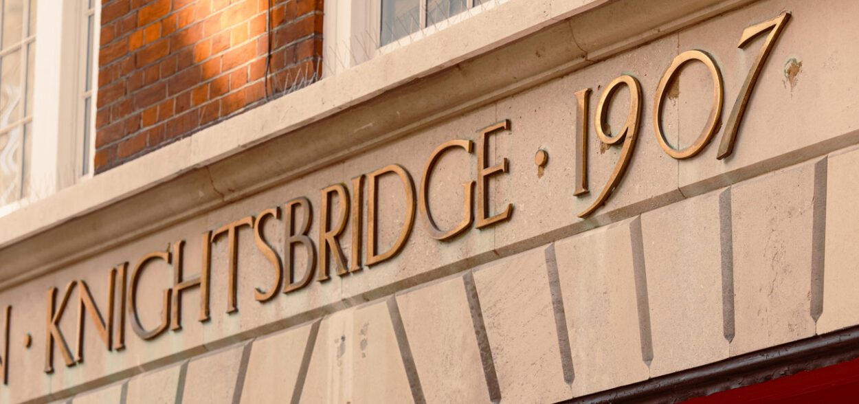An ornate sign sits above a door. It reads "Knightsbridge 1907".